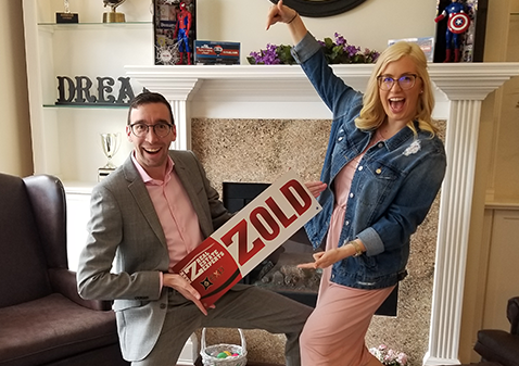 Happy couple with sold sign